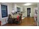 Eat-in kitchen featuring natural light from windows, a dining table, and white cabinetry at 155 6Th Sw St, Taylorsville, NC 28681