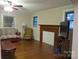 Cozy living room with hardwood floors, fireplace, ceiling fan and neutral color palette at 155 6Th Sw St, Taylorsville, NC 28681
