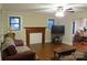 View of a living room featuring hardwood floors and a wooden fireplace at 155 6Th Sw St, Taylorsville, NC 28681