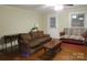 View of a well-lit living room with hardwood floors and two sofas at 155 6Th Sw St, Taylorsville, NC 28681
