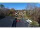 Aerial view of property showcasing a long drive with ample parking and mature trees at 194 E Jay Dr # 3, Taylorsville, NC 28681