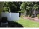 A serene backyard is surrounded by green trees and features a white privacy fence at 194 E Jay Dr # 3, Taylorsville, NC 28681