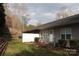 Backyard features a small patio area with a privacy fence and established shrubs at 194 E Jay Dr # 3, Taylorsville, NC 28681