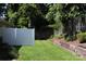 Picturesque backyard featuring a white privacy fence, mature trees, and lush green grass at 194 E Jay Dr # 3, Taylorsville, NC 28681