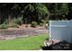 Spacious backyard with wooden retaining wall, white privacy fence and colorful foliage at 194 E Jay Dr # 3, Taylorsville, NC 28681