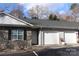 Charming townhome exterior showcasing stone accents, white garage doors, and a welcoming entrance at 194 E Jay Dr # 3, Taylorsville, NC 28681