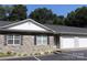 Inviting townhome with a stone facade, a one-car garage, and well-manicured landscaping at 194 E Jay Dr # 3, Taylorsville, NC 28681