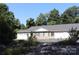 Charming townhome featuring a stone facade, two-car garage, and lush, landscaped front yard at 194 E Jay Dr # 3, Taylorsville, NC 28681