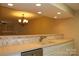 Well-lit kitchen featuring a double sink, white cabinets, and a modern stainless steel dishwasher at 194 E Jay Dr # 3, Taylorsville, NC 28681