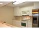 Modern kitchen features stainless steel refrigerator and oven, and overhead microwave, and ample white cabinets at 194 E Jay Dr # 3, Taylorsville, NC 28681