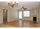 Cozy living room featuring laminate floors, a fireplace, and a ceiling fan at 194 E Jay Dr # 3, Taylorsville, NC 28681