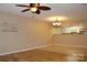 Open-concept living area with laminate floors, a ceiling fan, and a view of the kitchen at 194 E Jay Dr # 3, Taylorsville, NC 28681
