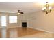 Bright living room featuring wood floors, a cozy fireplace, and natural light from a glass door at 194 E Jay Dr # 3, Taylorsville, NC 28681