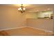 Well-lit living room featuring laminate floors, a ceiling fan, and a view into the kitchen at 194 E Jay Dr # 3, Taylorsville, NC 28681