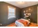 Small bedroom with dark-gray walls, hardwood floors, and a twin-sized bed at 405 Wakefield Dr # B, Charlotte, NC 28209