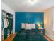 Comfortable bedroom with blue accent wall, closet, and wood flooring at 405 Wakefield Dr # B, Charlotte, NC 28209