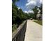 Picturesque view of the creek and the path along the side of the house, surrounded by trees at 405 Wakefield Dr # B, Charlotte, NC 28209