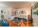 Cozy living room featuring a comfy couch, built-in shelving, and hardwood floors at 405 Wakefield Dr # B, Charlotte, NC 28209