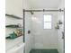 Sleek bathroom shower with black frame and fixtures, tile surround, and storage shelves at 405 Wakefield Dr # B, Charlotte, NC 28209