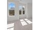 Bright, spacious bedroom with three large windows, neutral carpet, and white trim at 5027 Layman Dr # 24, Charlotte, NC 28226