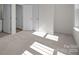 Spacious, well-lit bedroom with two doors and neutral carpet, with access to a bathroom at 5027 Layman Dr # 24, Charlotte, NC 28226