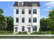 Modern three-story townhome featuring light siding, neutral trim, and professional landscaping at 5027 Layman Dr # 24, Charlotte, NC 28226