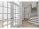 Bright foyer with wood-look floors, a staircase with wooden handrail, and glass French doors to another room at 5027 Layman Dr # 24, Charlotte, NC 28226
