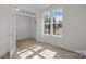 Bright living room featuring lots of light from windows and glass french doors, with view of community at 5027 Layman Dr # 24, Charlotte, NC 28226