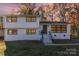 Two-story house with white exterior and landscaped lawn at 6521 Heatherbrook Ave, Charlotte, NC 28213