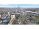 A scenic aerial view shows a city skyline over a neighborhood filled with mature trees, houses, and multi-unit dwellings at 819 E 36Th St, Charlotte, NC 28205
