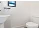 Simple half-bathroom with white sink and toilet at 819 E 36Th St, Charlotte, NC 28205