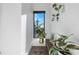 Hallway nook with bench, plants, and a window providing natural light at 819 E 36Th St, Charlotte, NC 28205