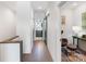 Hallway with white walls, hardwood flooring, and access to bathroom via sliding barn door at 819 E 36Th St, Charlotte, NC 28205