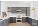 Spacious kitchen with gray cabinets, stainless steel appliances, white countertops, and hardwood floors at 819 E 36Th St, Charlotte, NC 28205