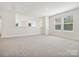 Bright bonus room features neutral walls, carpet and large windows letting in plenty of natural light at 1063 Bull Dog Ln, Wingate, NC 28174