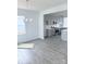 Dining area featuring wood-look floors, natural light, and an adjacent kitchen with modern appliances at 1063 Bull Dog Ln, Wingate, NC 28174