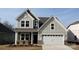 Charming two-story home with a white garage door and neutral siding at 1063 Bull Dog Ln, Wingate, NC 28174