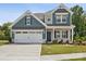 Beautiful two-story home with a well-manicured lawn, a two-car garage, and stylish curb appeal at 1063 Bull Dog Ln, Wingate, NC 28174