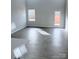 Bright living room with wood-look floors, backyard access, and plenty of natural light at 1063 Bull Dog Ln, Wingate, NC 28174