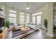 Sun-filled living room featuring vaulted ceilings, lots of natural light, and stylish striped rug at 11628 Eastwind Dr, Charlotte, NC 28273