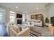 Bright living room with a fireplace, large windows, and stylish striped rug, creating a cozy atmosphere at 11628 Eastwind Dr, Charlotte, NC 28273