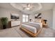 Elegant bedroom with a tray ceiling, wooden bed frame, and soft, neutral tones at 11628 Eastwind Dr, Charlotte, NC 28273