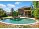 Beautiful backyard with a pool, spa, and screened porch, all surrounded by lush landscaping at 16515 Governors Club Ct, Charlotte, NC 28278
