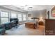 This bedroom features natural light, light gray walls, carpet, and an office desk and chair at 16515 Governors Club Ct, Charlotte, NC 28278