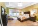 Spacious bedroom with large windows and dark wood furniture at 16515 Governors Club Ct, Charlotte, NC 28278