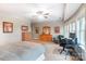 This bedroom features natural light, light gray walls, carpet, and an office desk and chair at 16515 Governors Club Ct, Charlotte, NC 28278