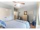 This bedroom features light blue walls, carpet, a ceiling fan, and a double door closet at 16515 Governors Club Ct, Charlotte, NC 28278