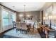 Dining room features hardwood floors, elegant chandelier, and plenty of natural light at 16515 Governors Club Ct, Charlotte, NC 28278
