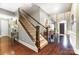 View of the entryway featuring a staircase with hardwood floors and a dark wood front door at 16515 Governors Club Ct, Charlotte, NC 28278