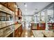 Open kitchen features stainless steel appliances, granite countertops, hardwood floors, and a view to the breakfast nook at 16515 Governors Club Ct, Charlotte, NC 28278